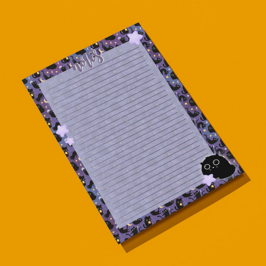 Notepad with purple border and cat design on an orange background