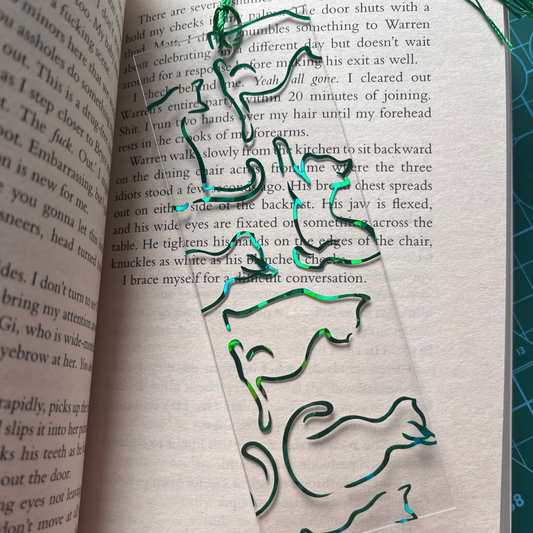 Holographic bookmark with cat design on an open book